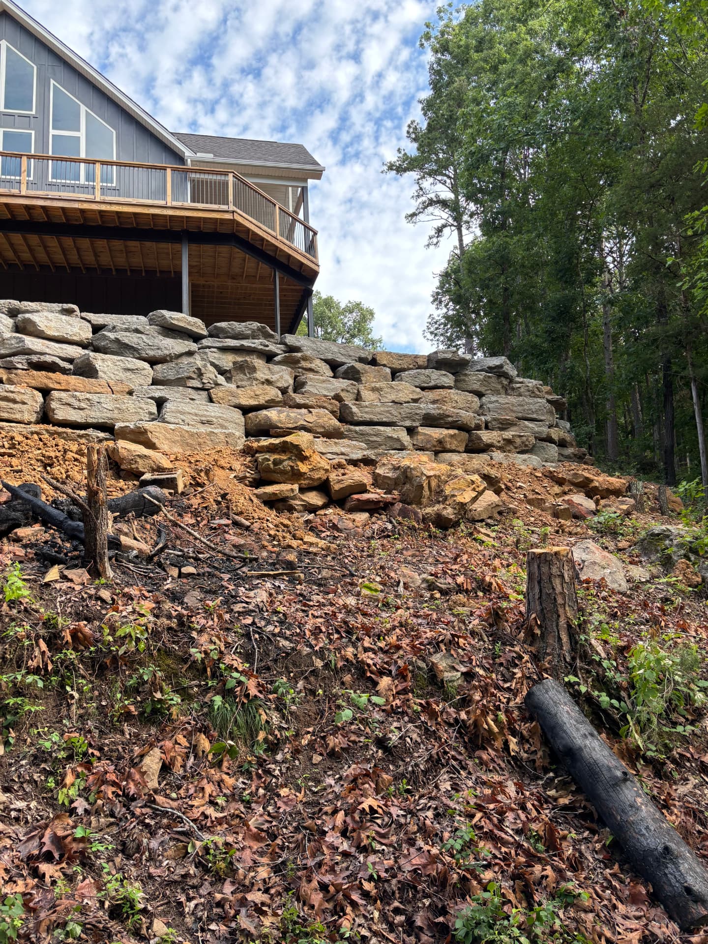 Slope cut, stumps pulled and boulders set course by course.