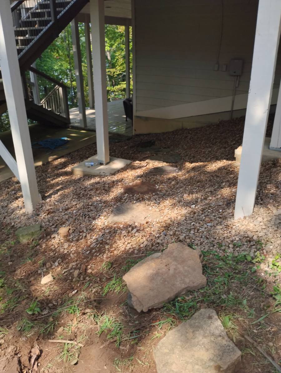 Graded gravel under a lake house deck to stop washouts and mud.