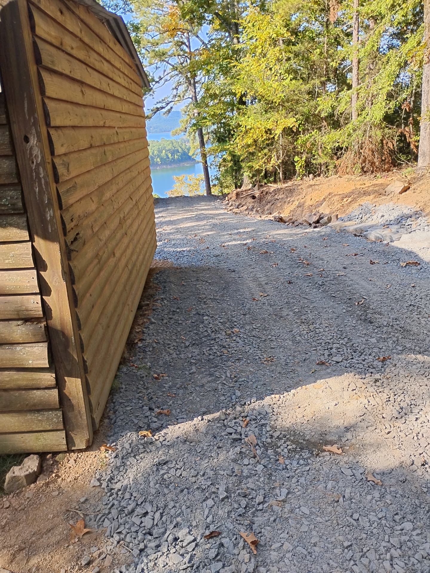 Drive widened and graveled down to a lakeside shed and turnaround.