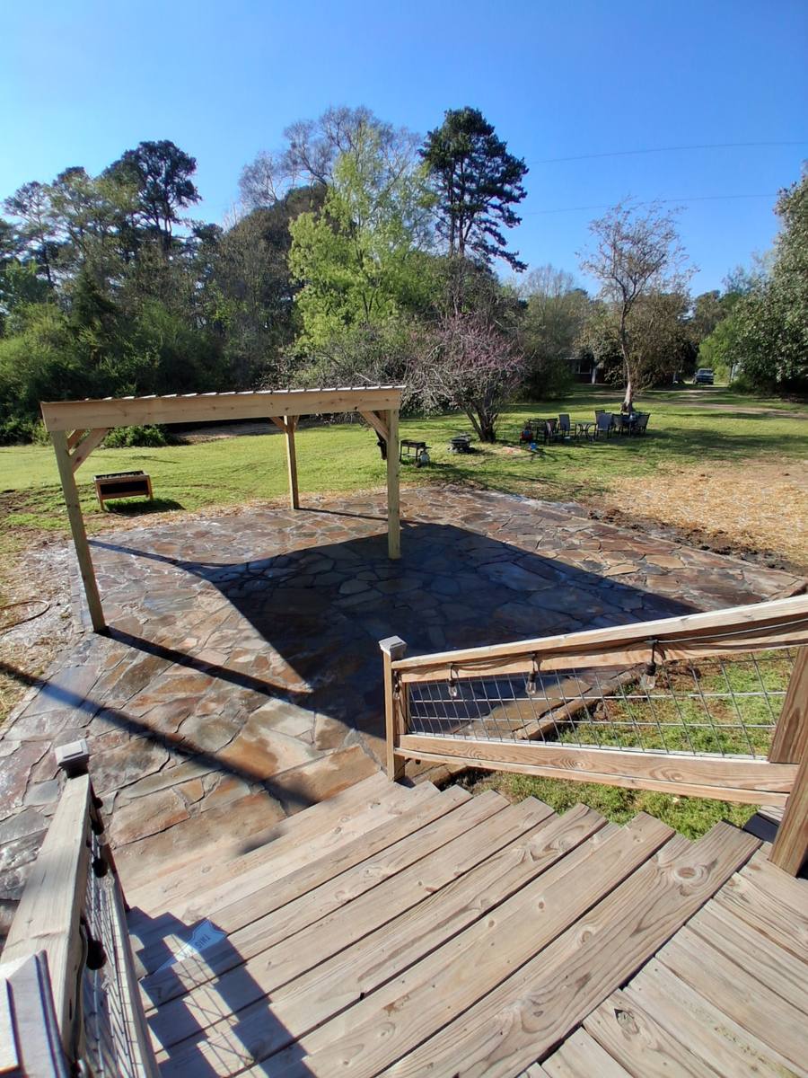 Cedar pergola set over a full natural flagstone patio in the back yard.